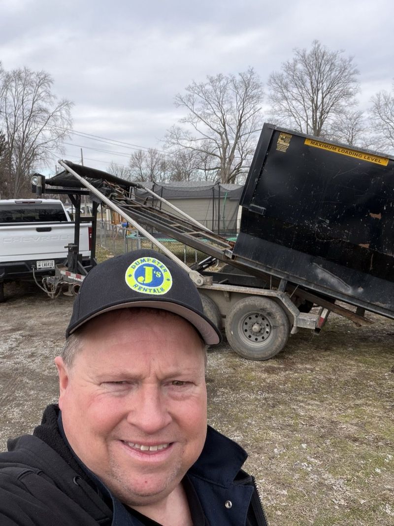 Jeff Hensley, owner of J's Dumpster Rentals, at his Richmond, IN yard with his truck and roll-off dumpster trailer